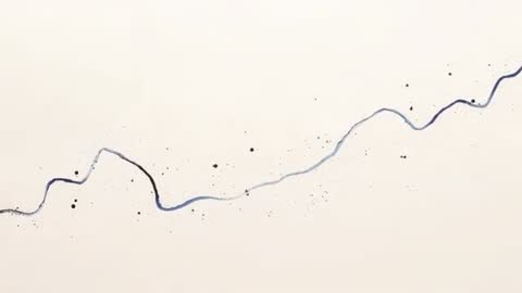 Flowing ink tracing sinuous blue-black line across pale paper with splatter motion