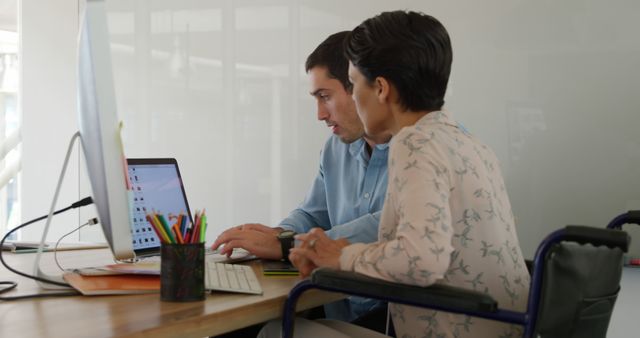 Colleagues Collaborating at Office Workspace with Laptop - Download Free Stock Images Pikwizard.com