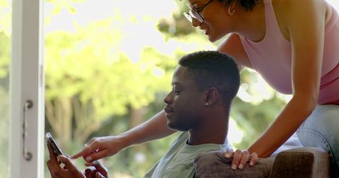 Cheerful Couple Enjoying Technology Together at Home