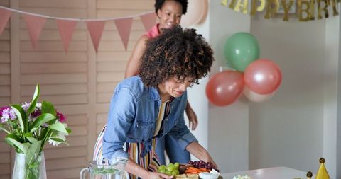 Women Preparing Birthday Celebration Decorated Home Party