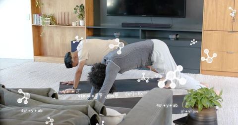 Two men practicing yoga at home with math overlay — living room fitness routine