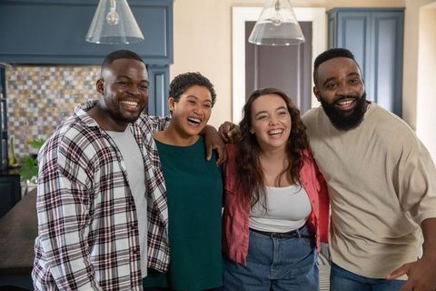 Diverse Friends Sharing Laughter in Modern Kitchen Setting