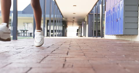 Student Walking Through School Corridor Slow Motion Perspective