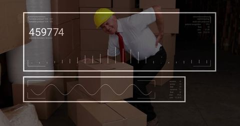 Warehouse supervisor experiencing back pain while lifting box with analytics overlay