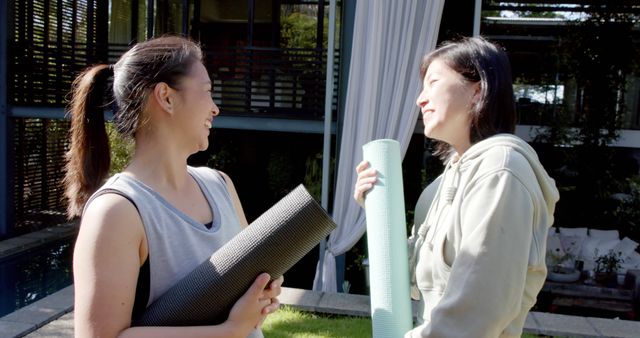 Two Women Holding Yoga Mats and Smiling Outdoors - Download Free Stock Images Pikwizard.com