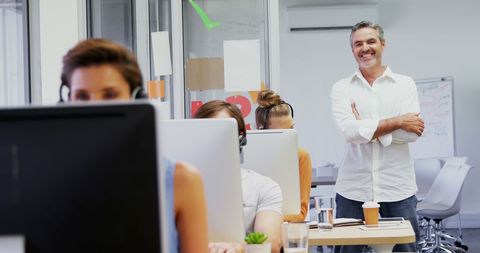 Confident Businessman Leading Focused Office Team