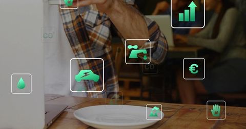Sipping coffee and viewing laptop with augmented reality sustainability icons in cafe