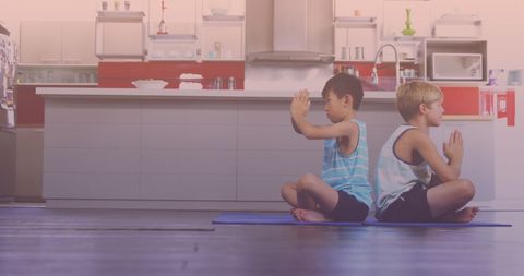 Young Brothers Practicing Yoga Together at Home