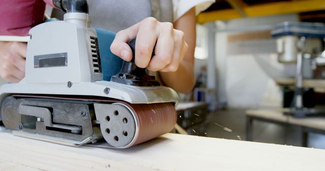 Close-Up of Carpenter Using Electric Sander on Wood - Download Free Stock Images Pikwizard.com