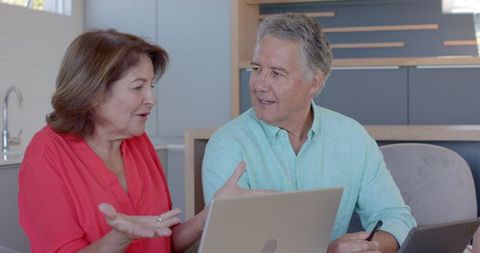 Senior Couple Smiling with Laptop, Engaging in Technology Use
