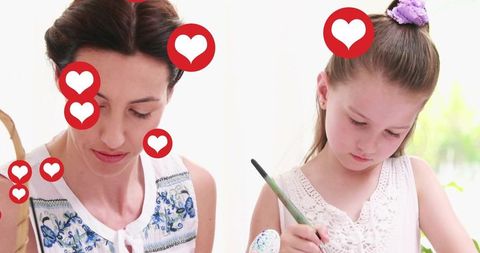 Mother and Daughter Decorating Eggs with Paintbrushes