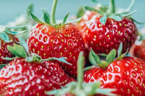 Vibrant fresh strawberries with green leaves close-up