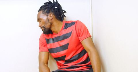 Frustrated athlete in locker room reflecting on performance