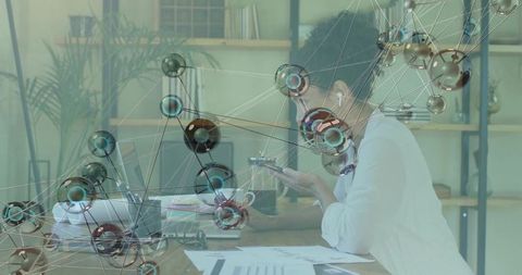 Woman Analyzing Global Technology while Working at Desk