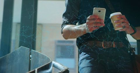 Businessman Utilizing Smartphone with Digital Data Overlay
