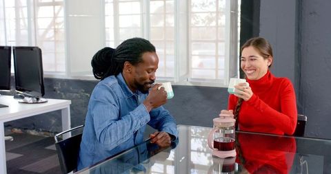 Diverse Colleagues Enjoying Coffee Break in Modern Office Setting