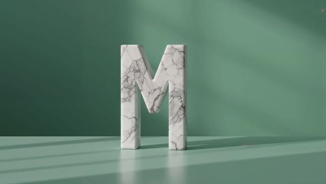 Marble letter m on mint green backdrop with shadows