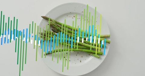 Displaying green asparagus on white plate with colorful waveform overlay