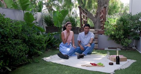Couple Enjoying Romantic Picnic in a Lush Garden