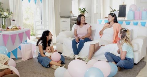 Diverse Friends Celebrating Baby Shower with Joyful Conversation