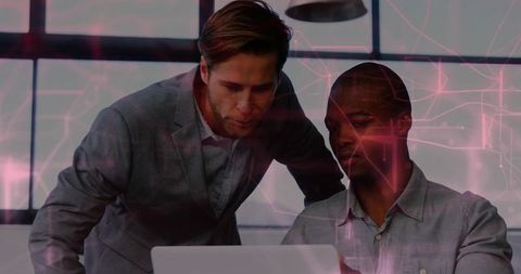Male Colleagues Collaborating on Laptop with Futuristic Pink Tech Overlay in Modern Office
