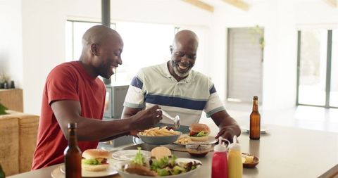 Family Dining, Father and Son Enjoying Burgers at Home