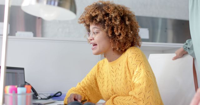 Young Woman Collaborating in Office Wearing Yellow Sweater - Download Free Stock Images Pikwizard.com