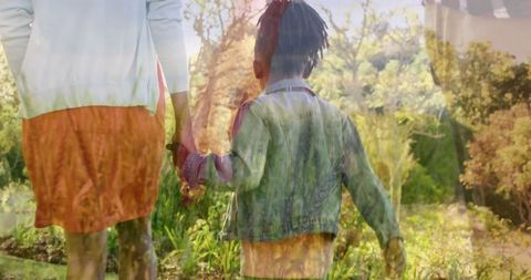 Father and child enjoying autumn walk in park