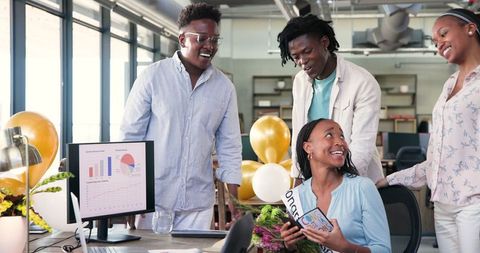 Diverse Team Celebrating Success with Joyful Office Congratulation