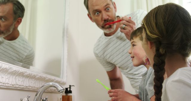 Father Teaching Daughter Toothbrushing While Looking In Mirror - Download Free Stock Images Pikwizard.com