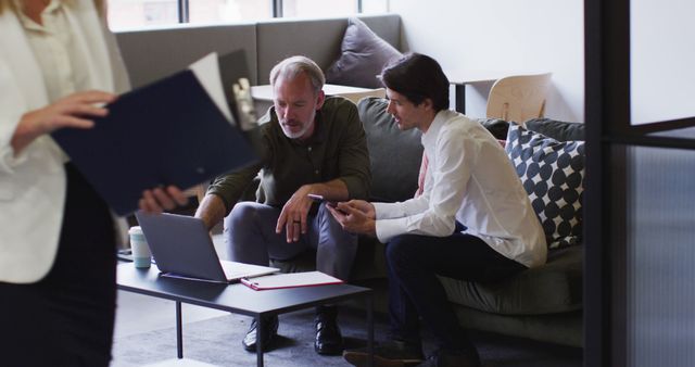 Businessmen Collaborating on Laptop in Modern Office Lounge - Download Free Stock Images Pikwizard.com