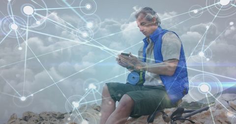 Senior Man Exploring Networking Connections During Outdoor Adventure