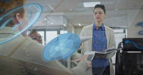 Business team using holographic interface during collaborative office meeting
