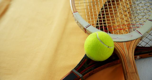 Vintage Tennis Rackets and Tennis Ball on Yellow Background - Download Free Stock Images Pikwizard.com