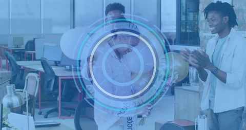 Colleagues celebrating milestone in modern open office with bouquet, balloons and applause