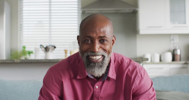 Smiling African American Man Sitting in Contemporary Kitchen - Download Free Stock Images Pikwizard.com