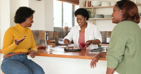 Women Preparing Tart Together in Cozy Home Kitchen