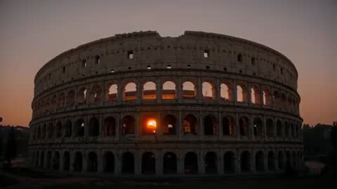 Sun Aligning Through Colosseum Arch at Sunset Creating Orange Flare Time-lapse Video