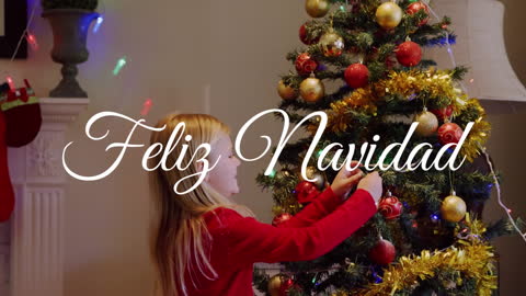 Joyful Girl Adding Ornaments to Christmas Tree at Home