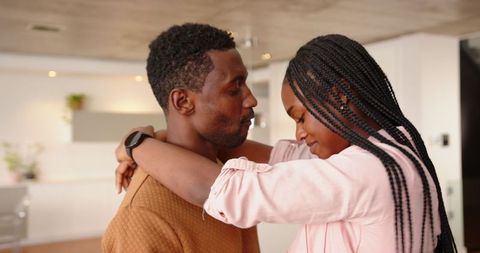 Couple Embracing in Modern Kitchen with Smartwatch and Decor