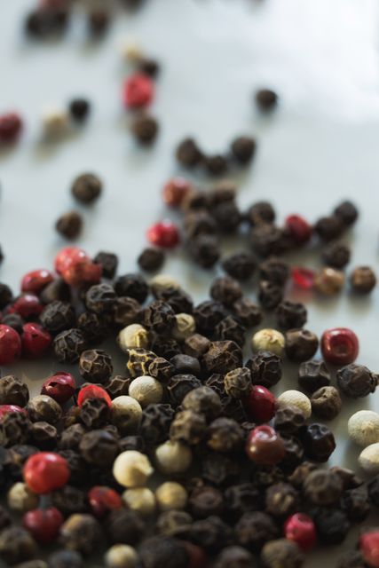 Close-up of mix peppercorns on white background