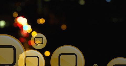 Digital speech bubbles over blurred city lights