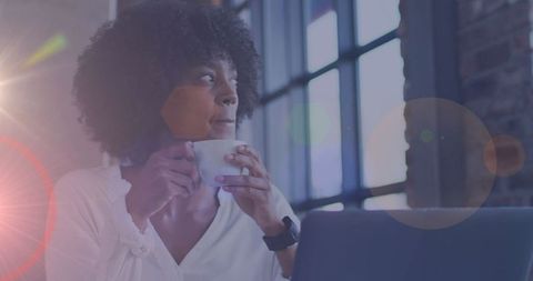 Reflective Woman Sipping Coffee in Cozy Cafe