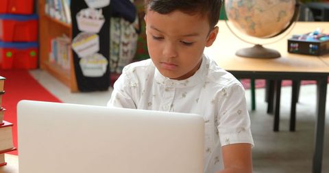 Focused Young Student Learning with Laptop in Classroom - Download Free Stock Images Pikwizard.com