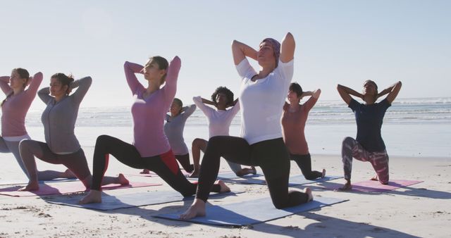 Diverse group practicing yoga on beach at sunrise - Download Free Stock Images Pikwizard.com