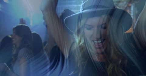 Young Woman Partying at Lively Nightclub Dancefloor