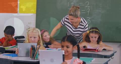 Teacher Guiding Diverse Students with Tablets in Classroom