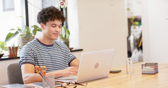 Young Man Working on Laptop in Home Office - Download Free Stock Images Pikwizard.com