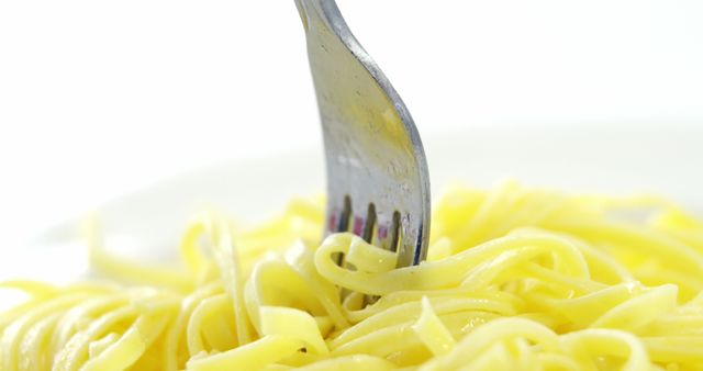 A fork twirls a serving of spaghetti, highlighting the simplicity of the dish. The close-up shot captures the texture of the pasta and the action of eating.