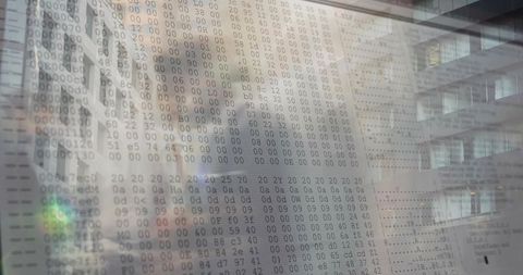 Displaying translucent hexadecimal data overlay on office atrium glass reflecting facade